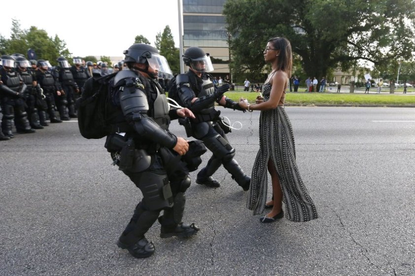 A demonstrator protesting the shooting death of Alton Sterling is detained by law enforcement near the headquarters of the Baton Rouge Police Department in Baton Rouge, Louisiana